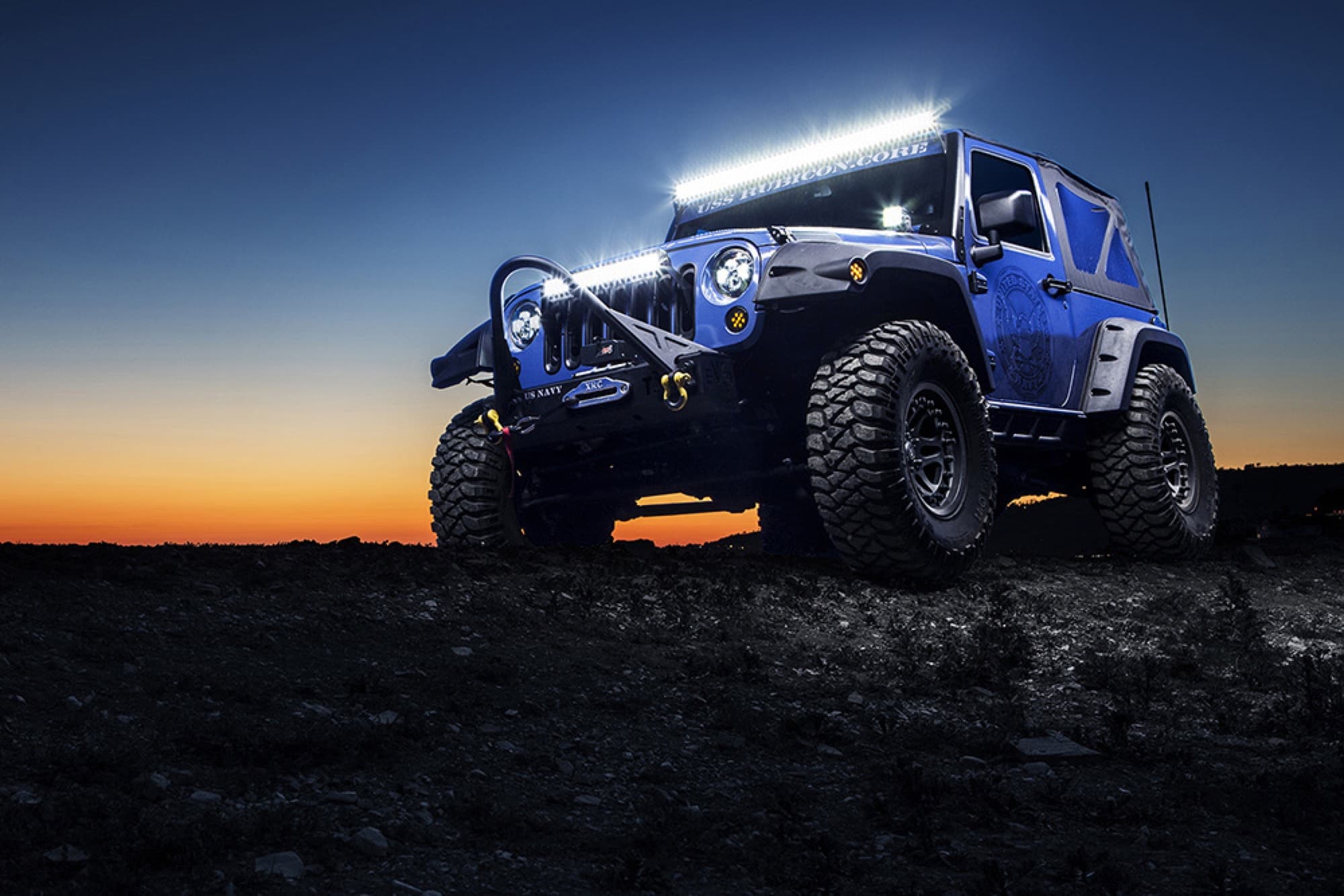 Jeep on trail at sunset with light bar engaged